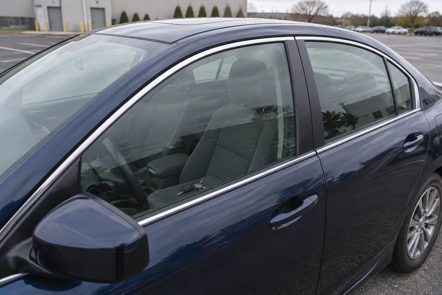 Car keys visible on the driver seat through a closed window.